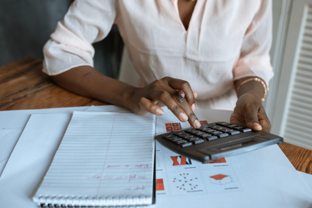 Femme avec une calculette qui calcule les dimensions de sa suite sous combles